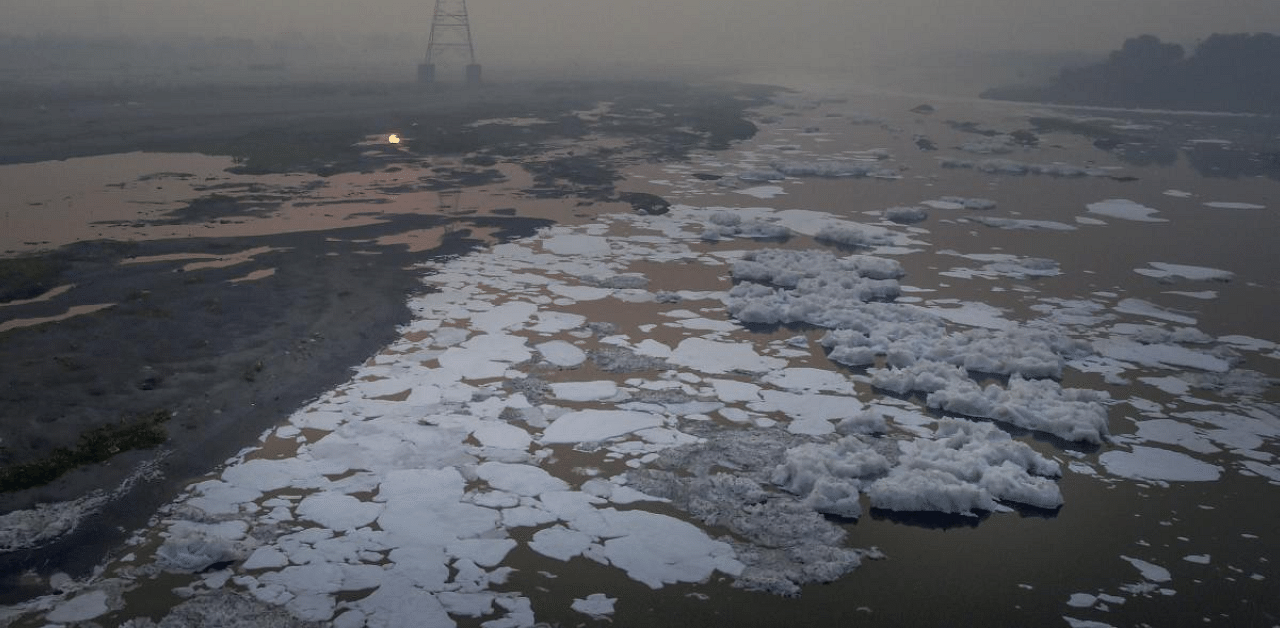 Toxic foam floats on the surface of Yamuna River at Kalindi Kunj, in New Delhi. Credit: PTI File Photo 