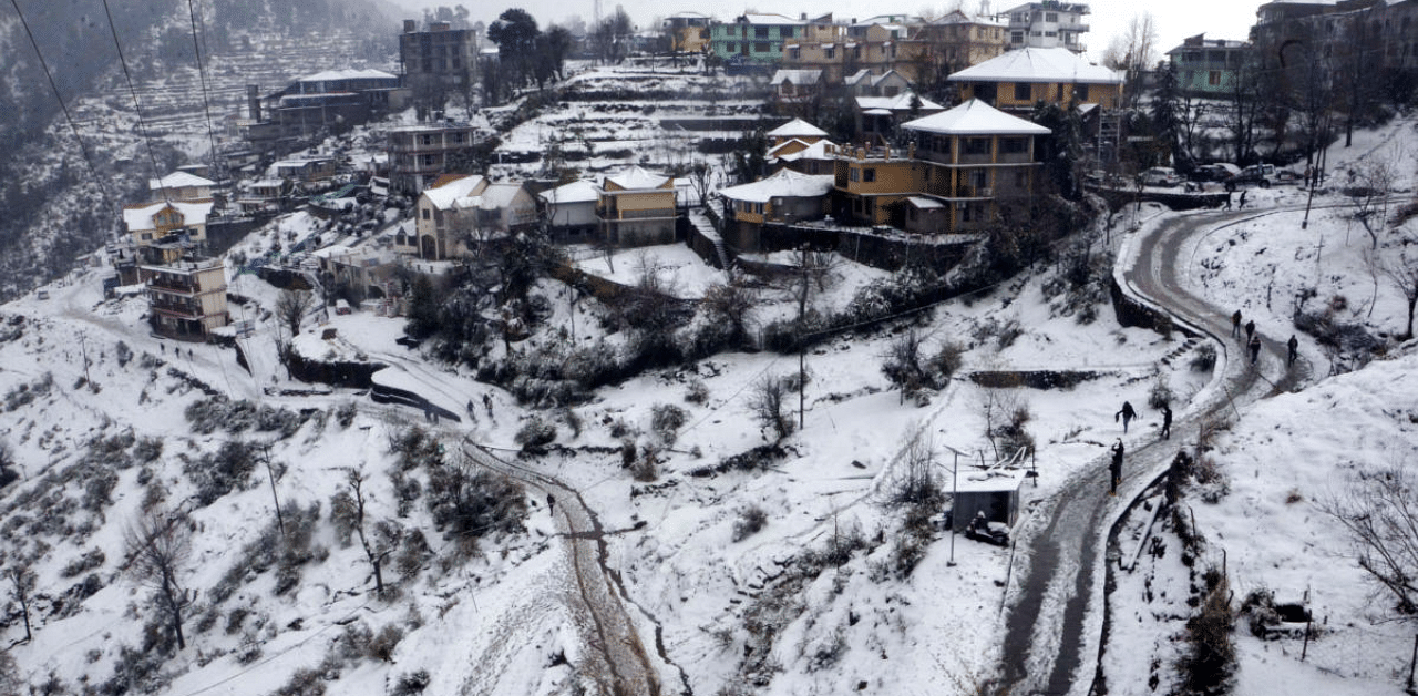 View of the snow-covered Naddi village after a fresh snowfall, near McLeodganj in Himachal Pradesh, Credit: PTI Photo