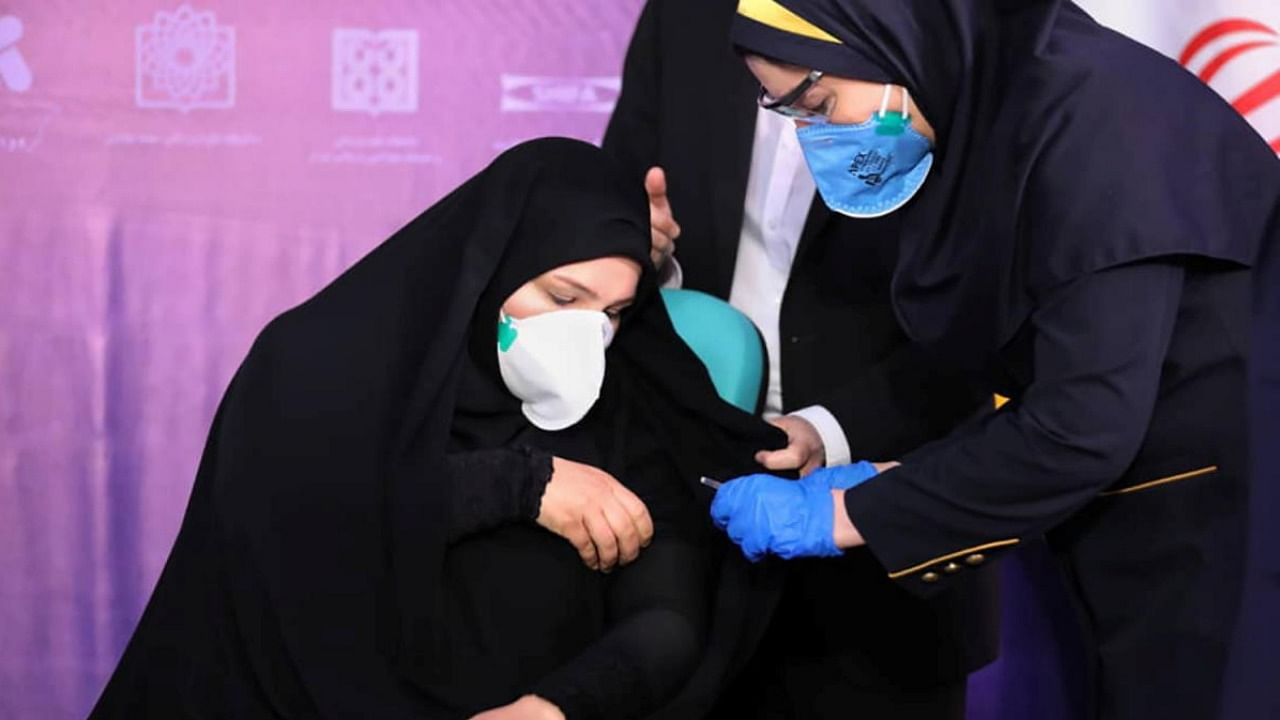 A nurse prepares to inject a volunteer taking part in an Iranian coronavirus disease vaccine trial in Tehran. Credit: Organization of the Execution of Imam Khomeini's Order/WANA via Reuters.