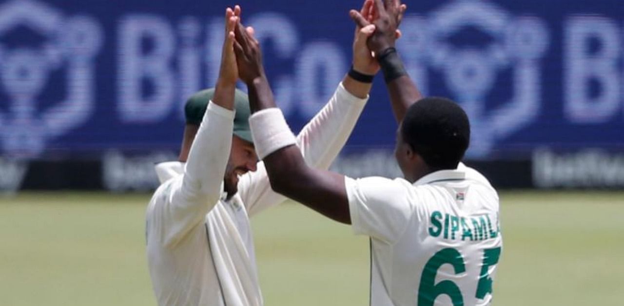 South Africa's Lutho Sipamla celebrates with teammates after the dismissal of Sri Lanka's Wanindu Hasaranga during the fourth day of the first Test cricket match between South Africa and Sri Lanka at SuperSport Park in Centurion. Credit: AFP.