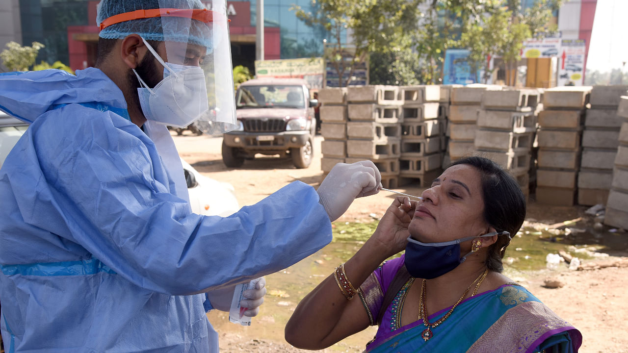 Medical staff collecting nasal swab for Corona Virus test in Covid19 unlock at free checkup centre, Kengeri, Mysuru road in Bengaluru on Friday, 11 December 2020. Credit: DH Photo/S K Dinesh