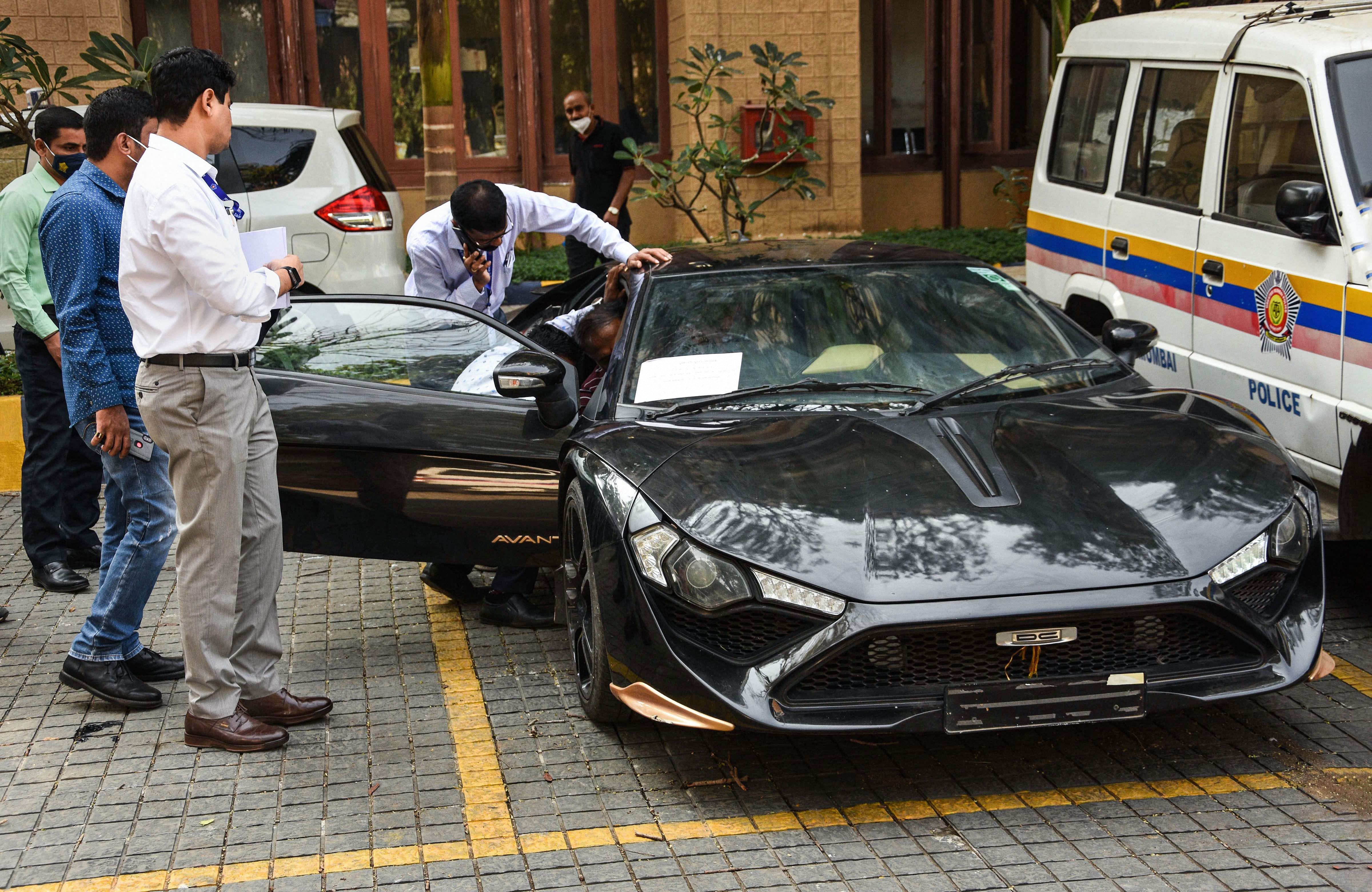 Police personnel investigate the seized Avanti car of renowned car designer Dilip Chhabria after he was produced at Killa court in connection with cheating and forgery case, in Mumbai, Tuesday, Dec. 29, 2020. Credit: PTI Photo