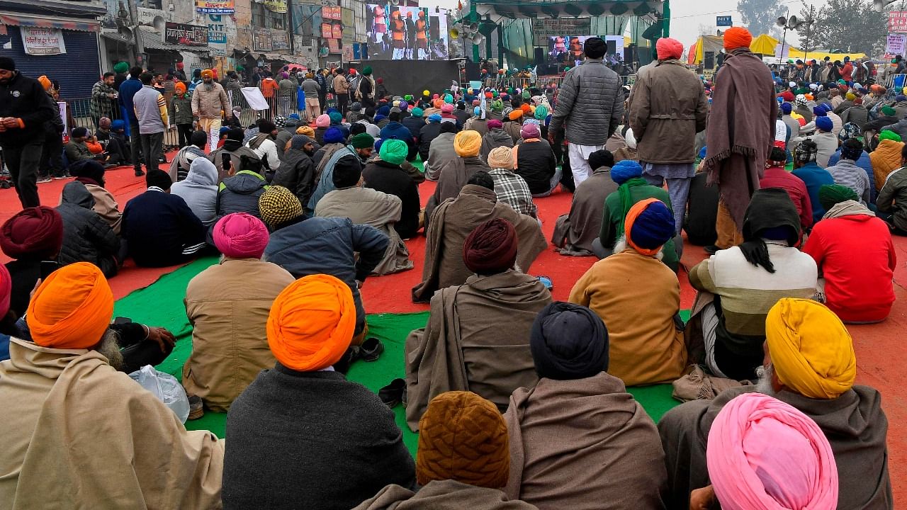 Protesting farmers listen to their leaders as they continue to demonstrate against the central government's recent agricultural reforms while blocking a highway at the Delhi-Haryana state border in Singhu on December 30. Credit: AFP Photo