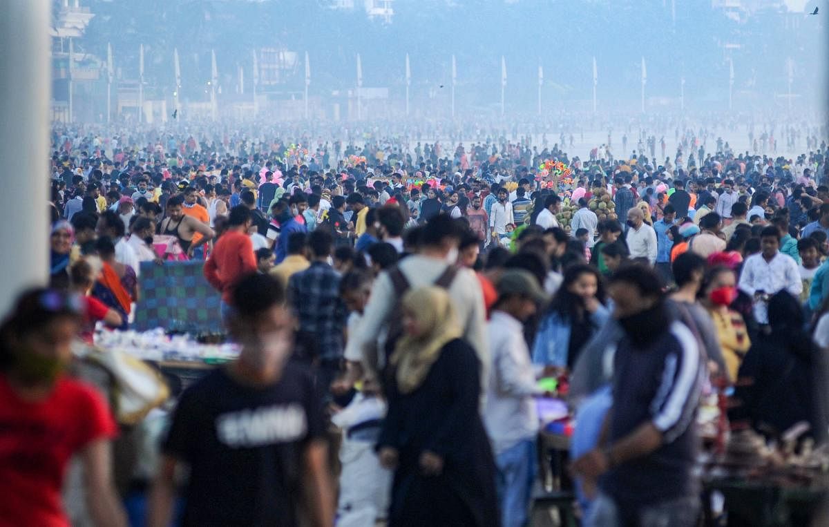 People, not adhering to social distancing norms, visit Juhu Chowpatty amid the coronavirus pandemic, in Mumbai. Credit: PTI. 