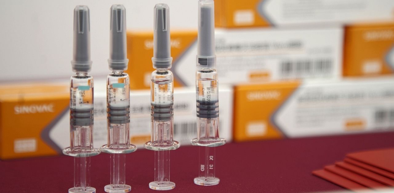 Vials of Sinovac Biotech’s CoronaVac SARS-CoV-2 vaccine. The challenge of manufacturing, distributing and administering billions of doses means many developing nations may have little choice but to use Chinese vaccines. Credit: Nicolas Bock/Bloomberg.