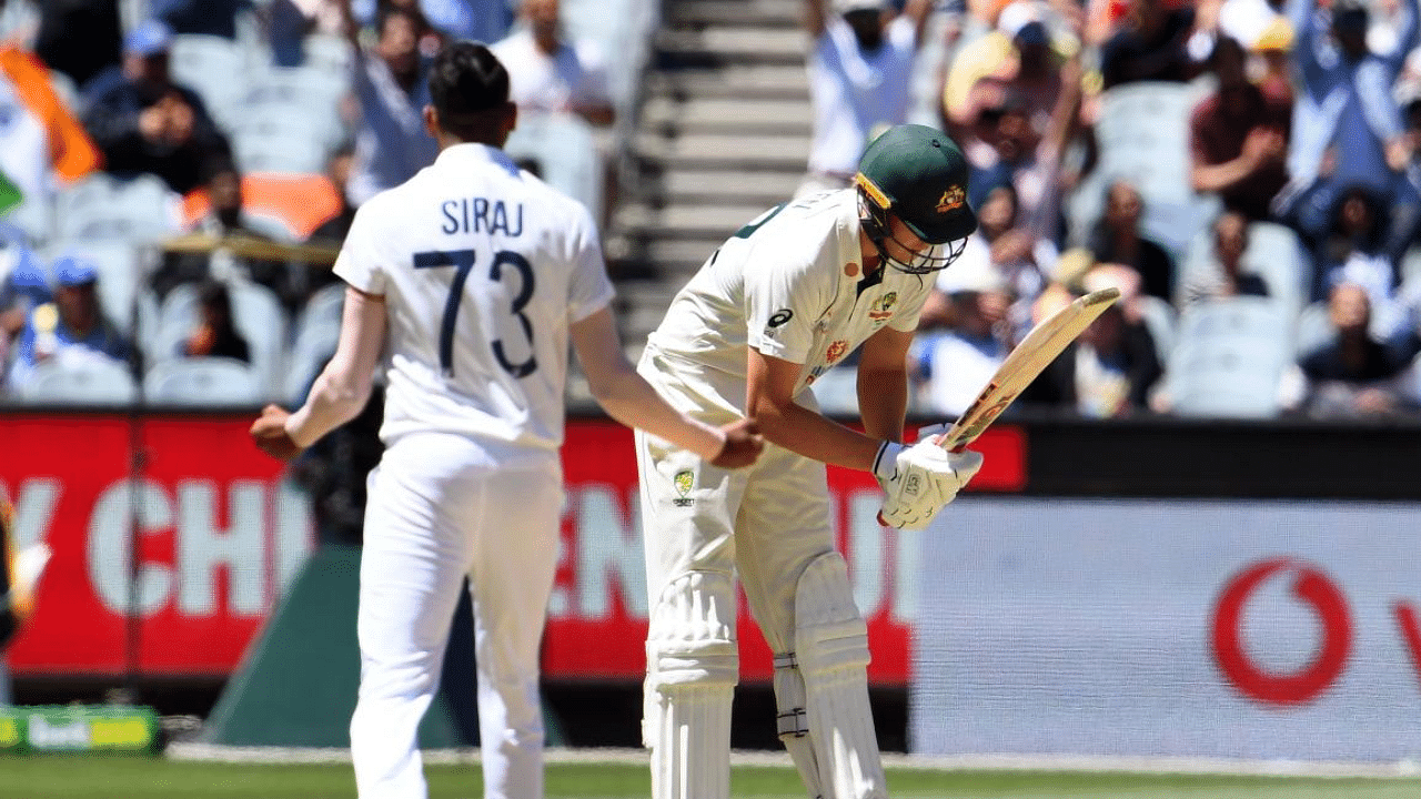 Australia's Cameron Green (R) reacts after been dismissed by Mohammed Siraj (L) on the fourth day of the second cricket Test match between Australia and India played at the MCG in Melbourne. Credit: AFP