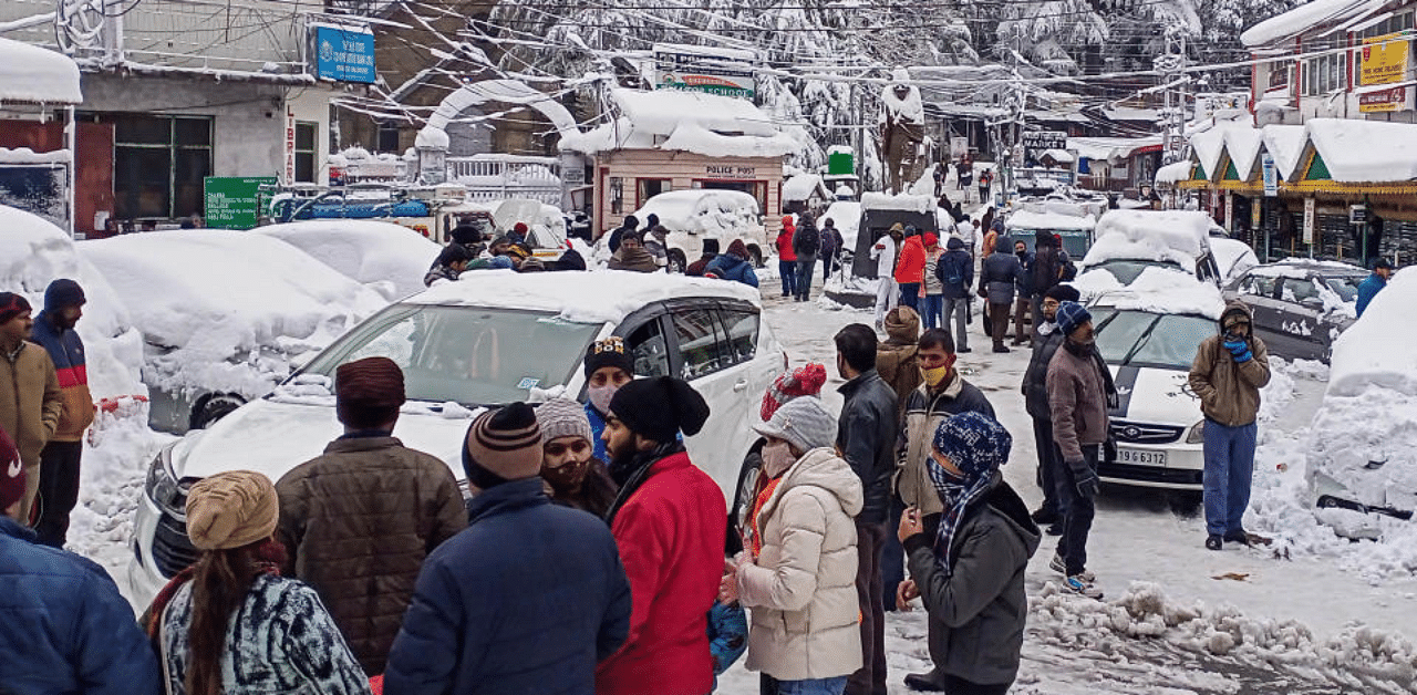 Tourists arrive in Dalhousie after heavy snowfall in Dhauladhar mountain range, in Himachal Pradesh, Monday, Dec. 28, 2020. Credit: PTI Photo