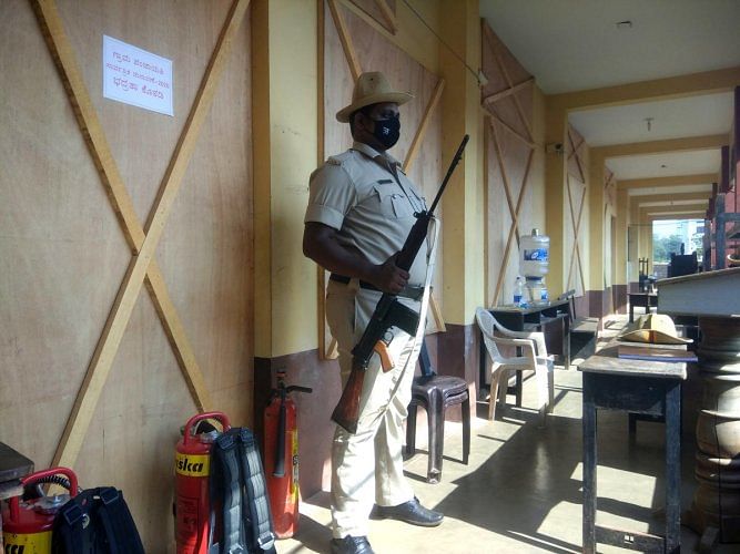 A police personnel on duty at the SMS Pre-University College in Brahmavar where counting of votes will be held on Wednesday. Credit: DH Photo