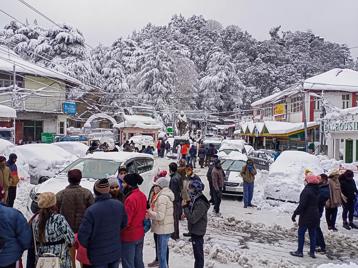 Tourists arrive in Dalhousie after heavy snowfall in Dhauladhar mountain range, in Himachal Pradesh. Credit: PTI. 