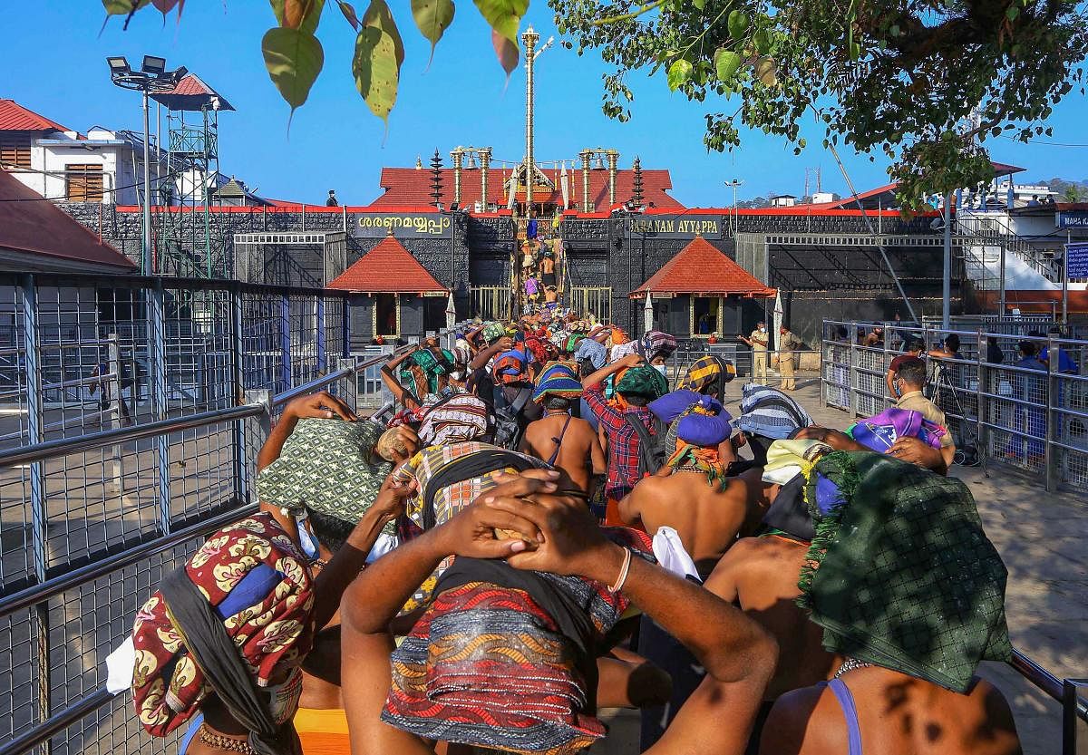 Devotees arrive to attend 'Mandala Puja', at Sabarimala Temple in Pathanamthitta district. Credit: PTI. 