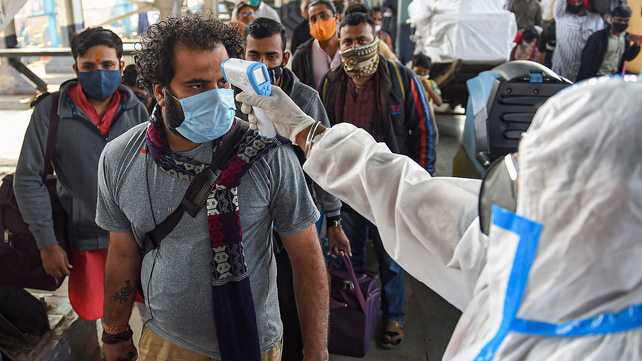 Passengers undergo thermal screening, amid coronavirus pandemic, at Bandra Terminus Railway Station in Mumbai. Credit: PTI Photo