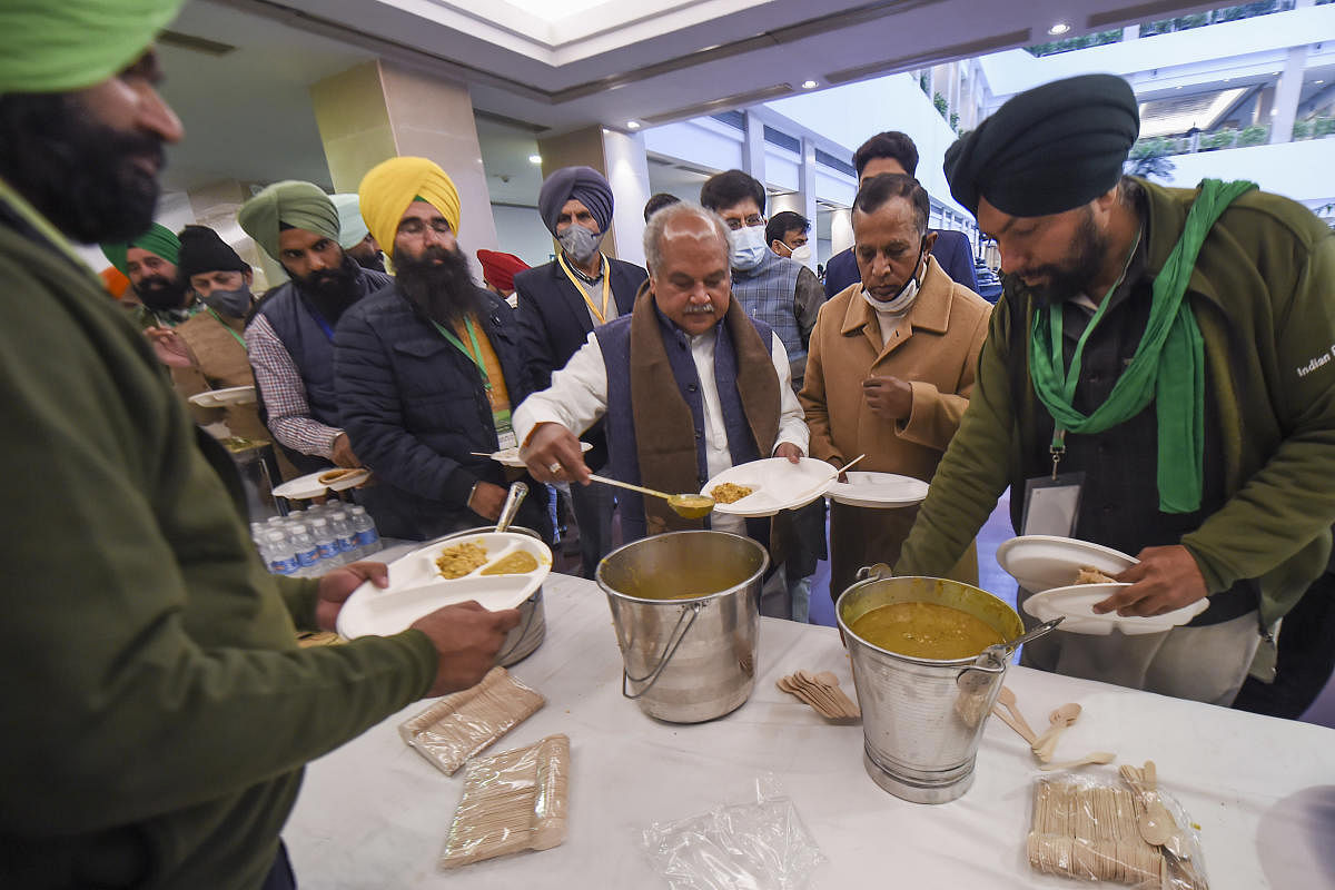 Union Minister for Agriculture & Farmers Welfare Narendra Singh Tomar has 'langar' (food) with farmers' representatives during a meeting over the new farm laws, at Vigyan Bhawan in New Delhi, Wednesday, Dec. 30, 2020. Credit: PTI Photo