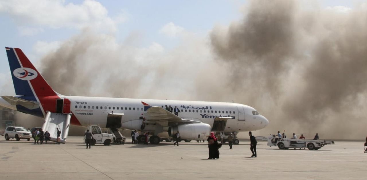 Dust rises after explosions hit Aden airport, upon the arrival of the newly-formed Yemeni government in Aden. Credit: Reuters Photo