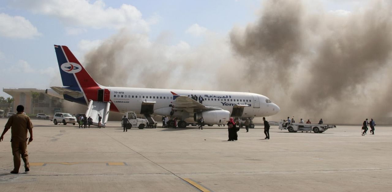 Dust rises after explosions hit Aden airport, upon the arrival of the newly-formed Yemeni government in Aden. Credit: Reuters.