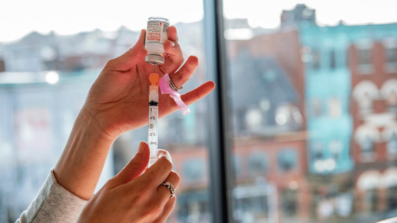 A nurse prepares a syringe with the Moderna vaccine at the East Boston Neighborhood Health Center (EBNHC) in Boston, Massachusetts. Credit: AFP