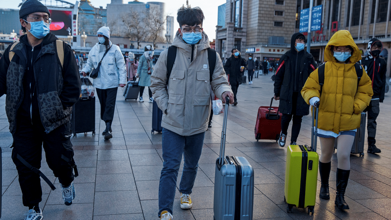 Travellers push suitcases outside Beijing Railway Station following an outbreak of the coronavirus disease in Beijing. Credit: Reuters Photo