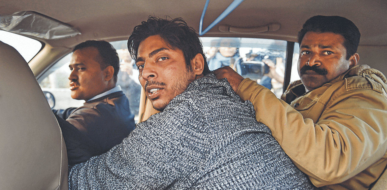 Police take away a man, identified as Kapil Gujjar, after he allegedly opened fire in the Shaheen Bagh area of New Delhi. Credit: PTI