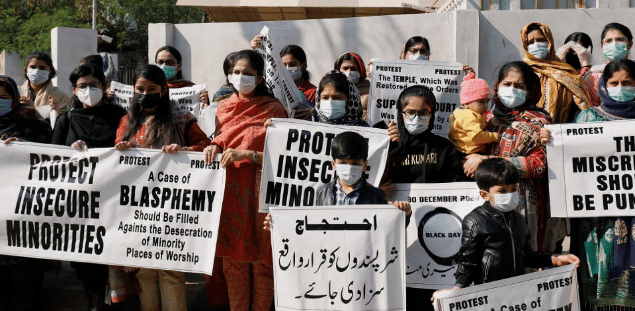 People from the Hindu community hold signs and banners to condemn the attack on a century-old Hindu temple in northwestern Pakistan, during a protest outside Supreme Court building in Karachi, Pakistan December 31, 2020. Credit: Reuters Photo