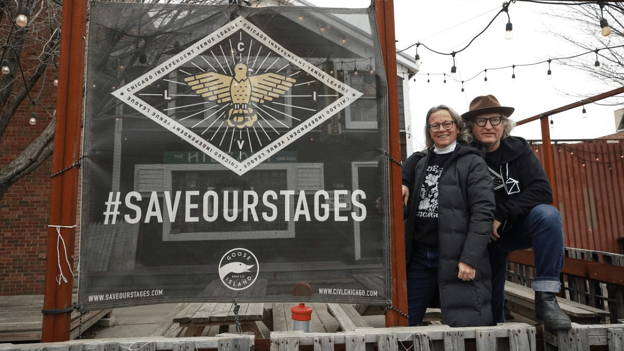 Katie and Tim Tuten, co-owners of The Hideout bar and live music venue pose for a picture outside of their business in Chicago, Illinois. Credit: AFP File Photo