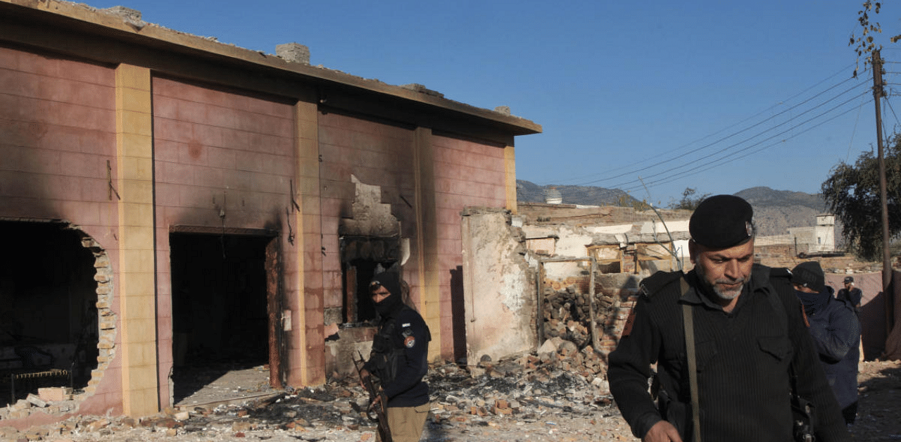 Police officer stand guar in a Hindu temple which was set on fire and demolished by a mob led by Islamists, in Karak, Pakistan. Credit: AP Photo