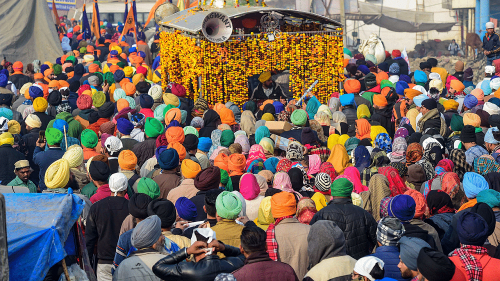 Sikh devotees take part in a religious procession (Nagar Kirtan) at the Singhu border during farmers' ongoing protest against new farm laws. Credit: PTI Photo