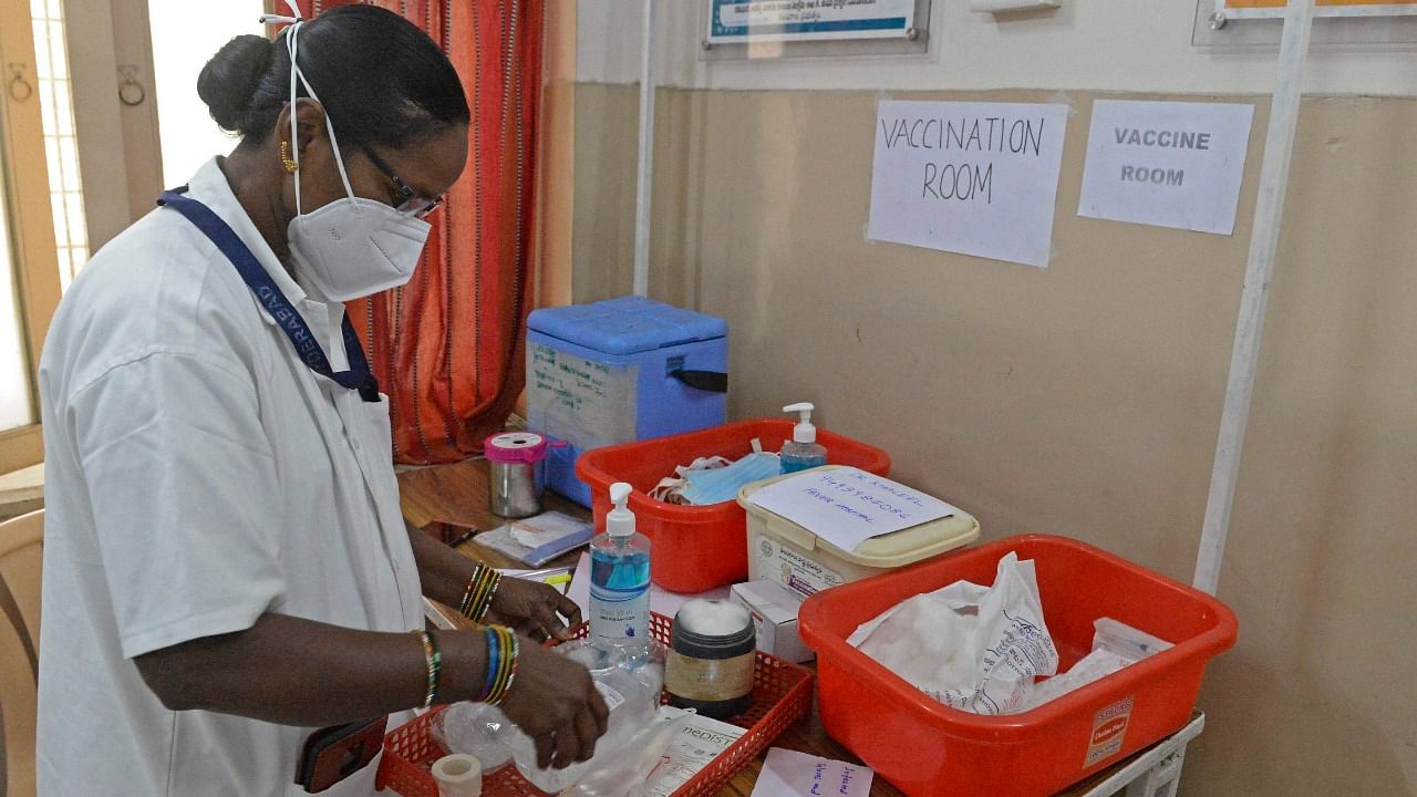 A health official prepares a vaccine kit as she takes part in dry run or a mock drill for Covid-19 coronavirus vaccine delivery at a primary health centre in Hyderabad. Credit: AFP Photo