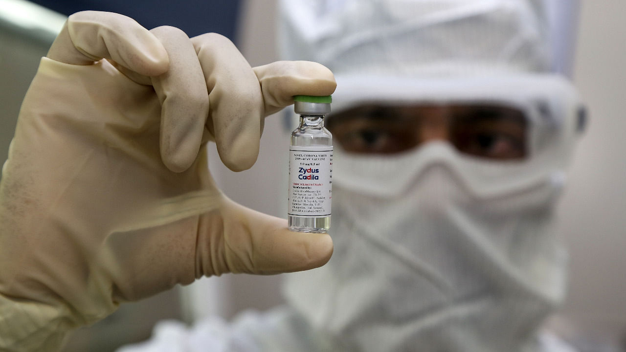 A pharmaceutics worker shows a shot of a vaccine developed by Zydus Cadila against Covid-19. Credit: AFP Photo