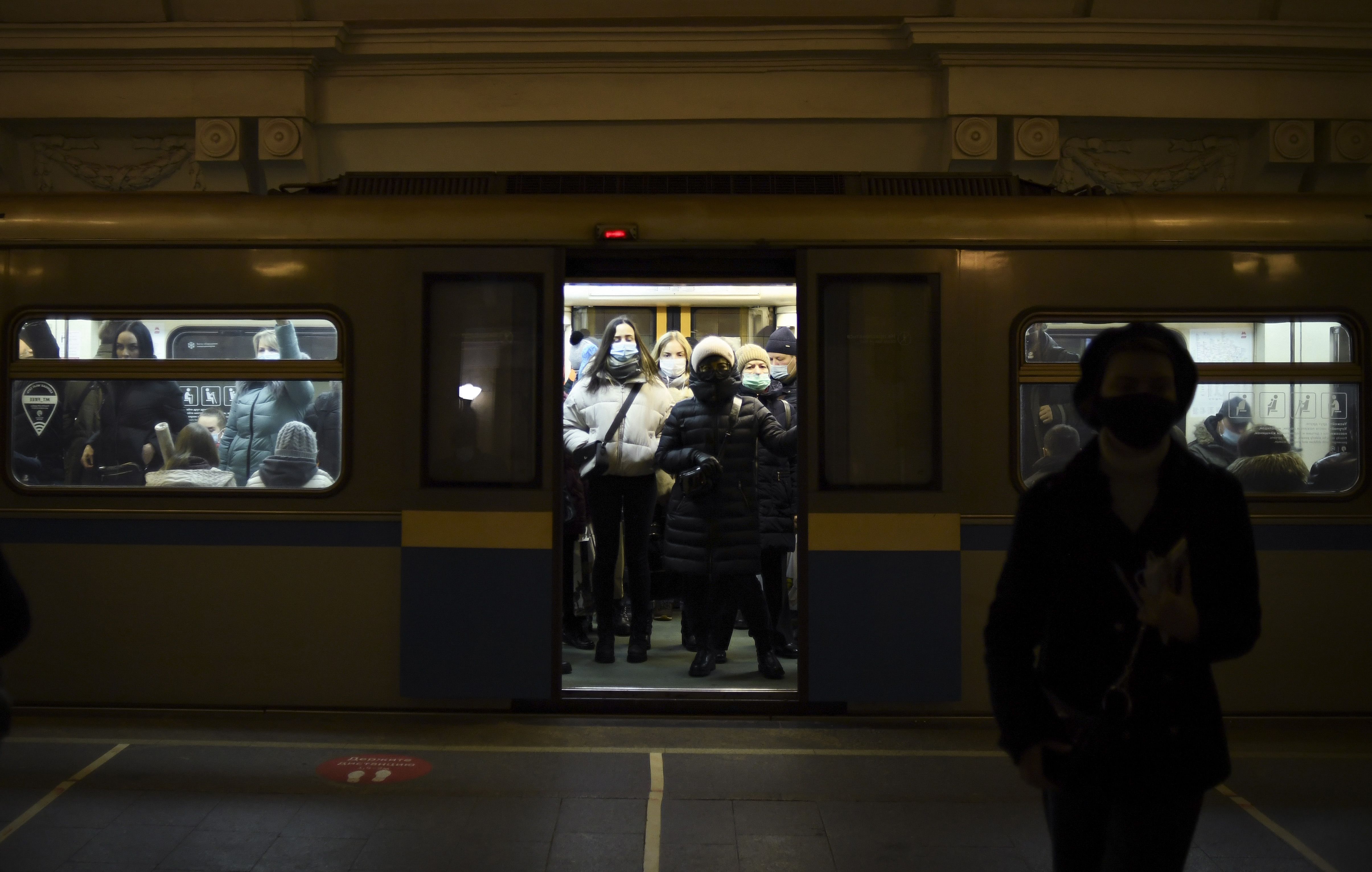 Commuters wearing face masks stand in a metro train in Moscow. Credit: AFP File Photo