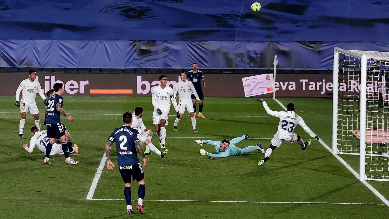 Real Madrid's French defender Ferland Mendy (R) and Real Madrid's Belgian goalkeeper Thibaut Courtois (2ndR) block a shot on goal during the Spanish League football match between Real Madrid and Celta Vigo. Credit: AFP Photo