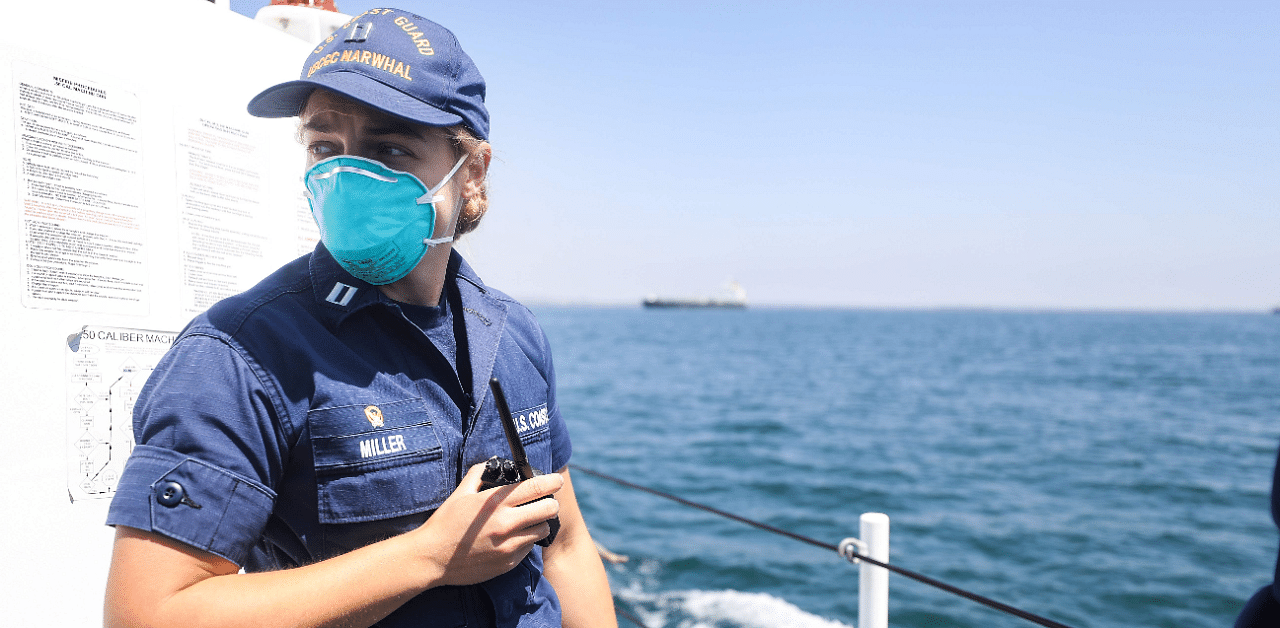 United States Coast Guard Lieutenant Caroline Miller wears a face mask aboard a patrol boat. Credit: AFP