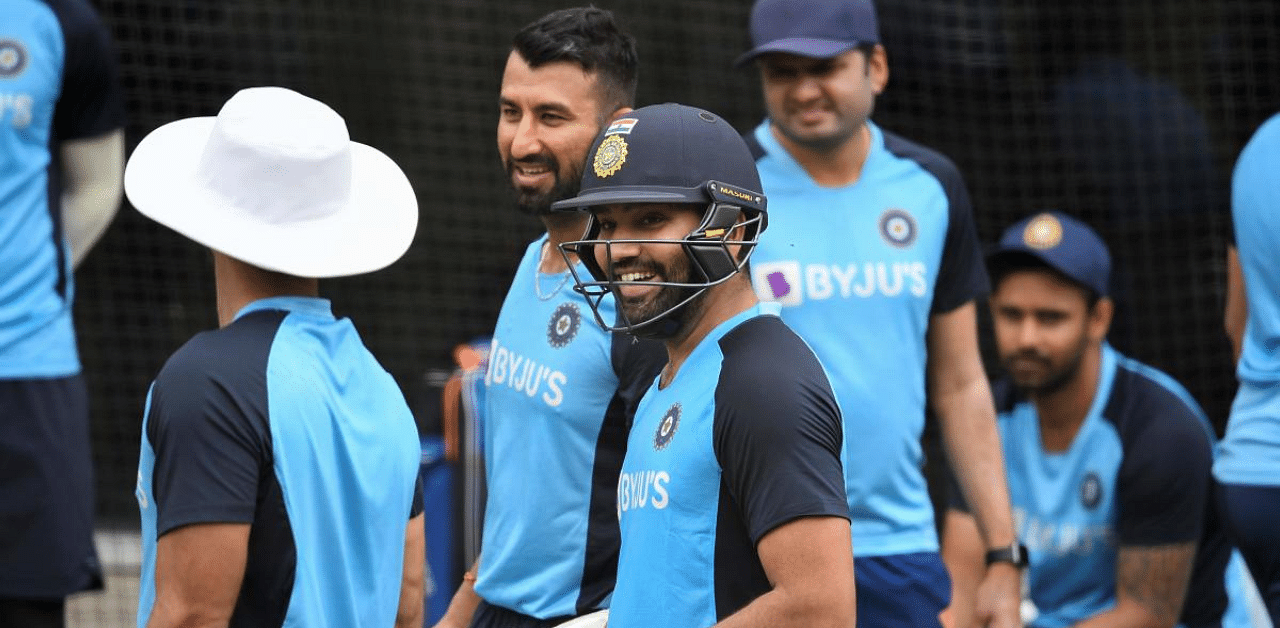 India's Rohit Sharma (C) chats with teammates during a training session at the MCG in Melbourne. Credit: AFP Photo