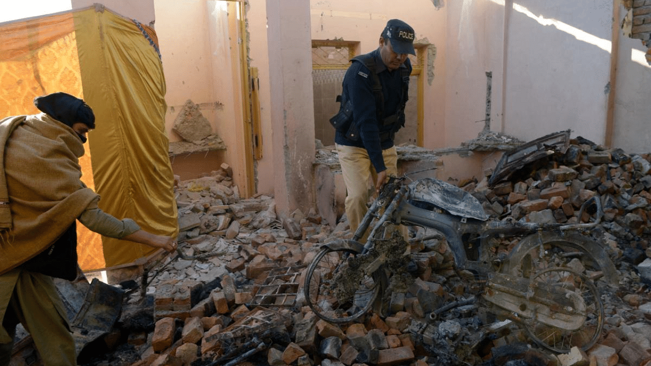 Policemen inspect the burnt Hindu temple a day after a mob attacked the temple in a remote village in Karak district, some 160 kms southeast of Peshawar. Credit: AFP File Photo