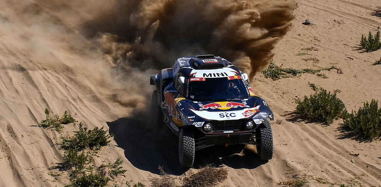 Mini's Spanish driver Carlos Sainz and co-driver Lucas Cruz compete during Stage 1 of the 2021 Dakar Rally between Jeddah and Bisha in Saudi Arabia. Credit: AFP Photo