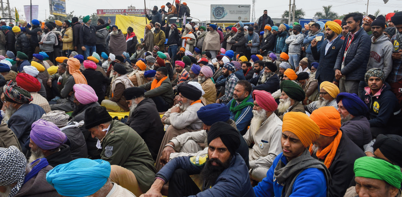 Farmers during their protest against the new farm laws, at Singhu border in New Delhi, Sunday. Credit: PTI Photo