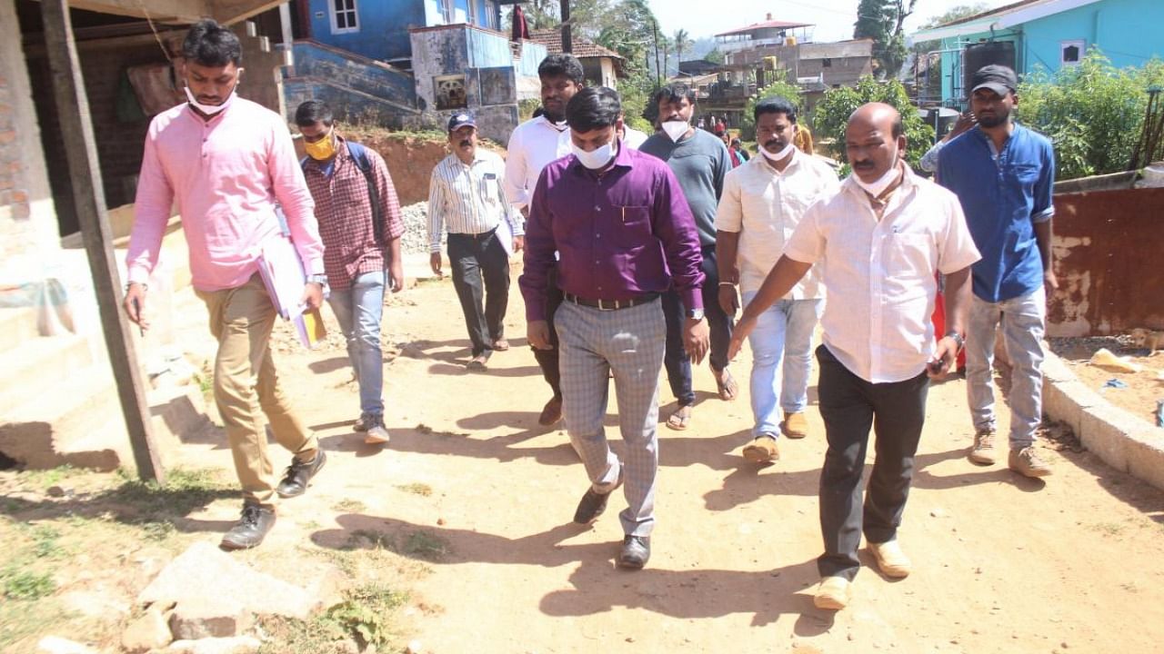 CMC Commissioner Ramdas inspects various layouts in Madikeri. JD(S) district unit president K M B Ganesh is also seen. Credit: DH.
