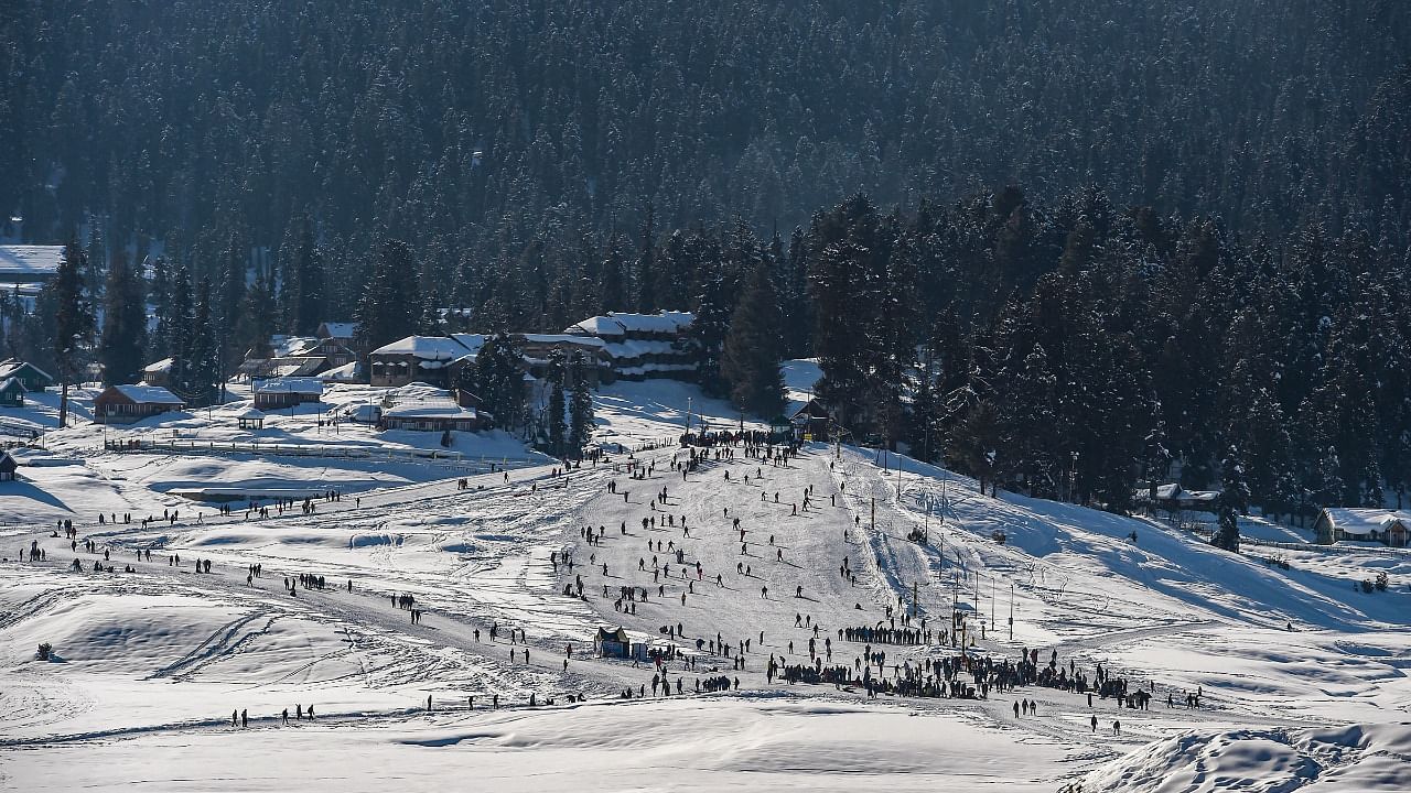 Tourists enjoy skiing on the slopes of the famous ski resort of Gulmarg. Credit: PTI Photo