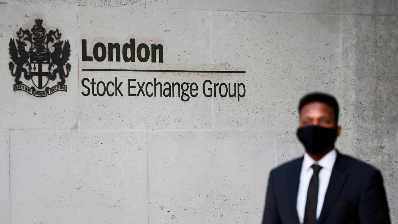 A security guard stands beside the logo for the London Stock Exchange Group outside the stock exchange in London. Credit: AFP Photo