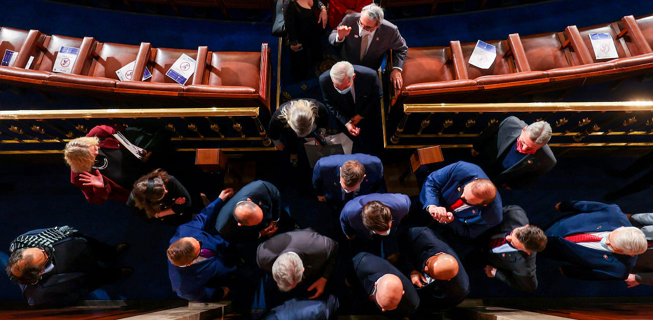 Members of the house depart after the first session of the 117th Congress in the House Chamber at the US Capitol. Credit: AFP Photo