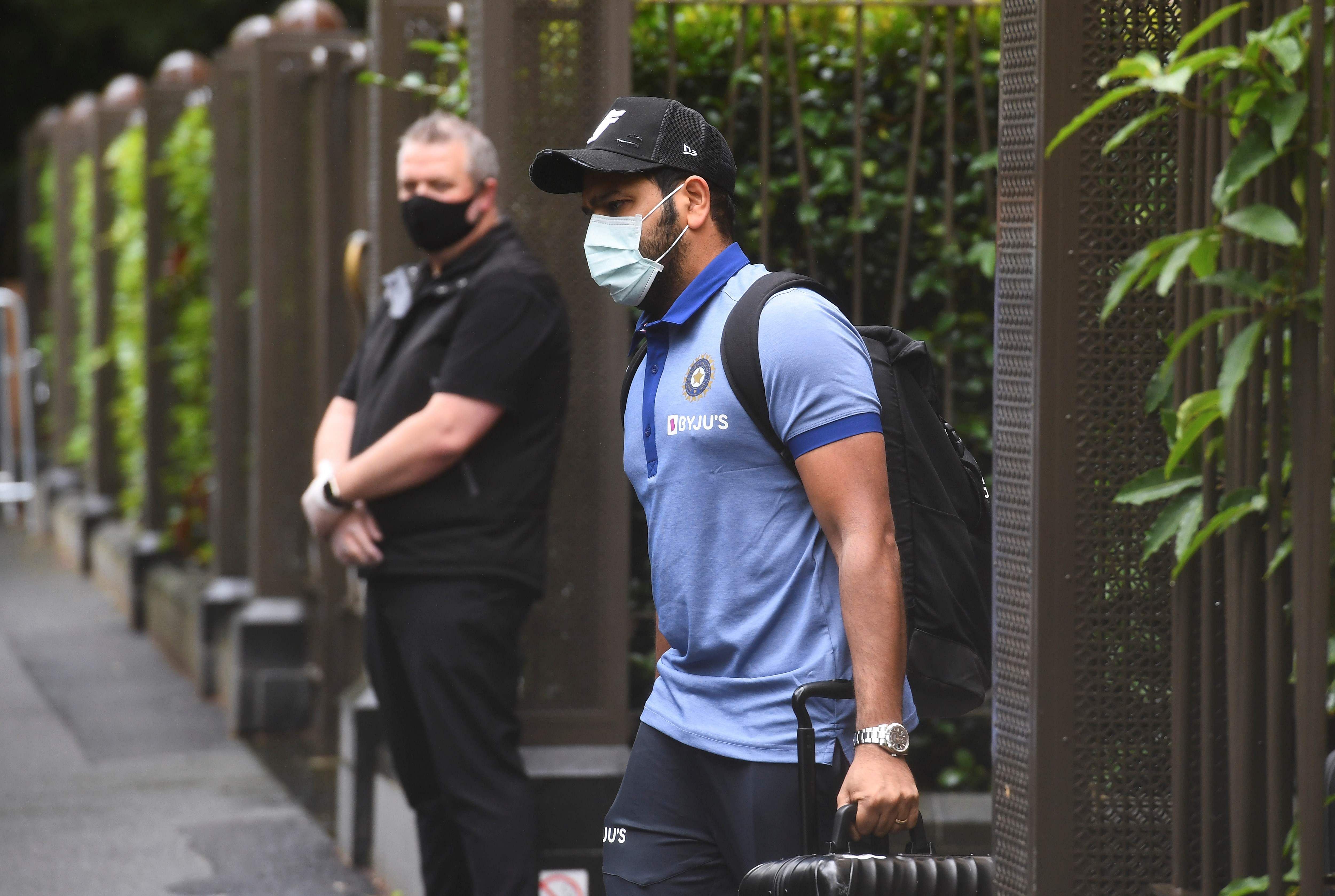 India's Rohit Sharma (R) leaves the team's hotel in Melbourne, as the Australian and Indian cricket teams relocate to Sydney for the third cricket Test on January 7. Credit: AFP Photo