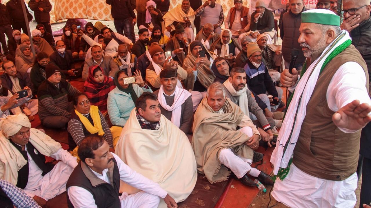 Bharatiya Kisan Union (BKU) Spokesperson Rakesh Tikait addresses farmers during their protest against the new farm laws, in Gurugram.