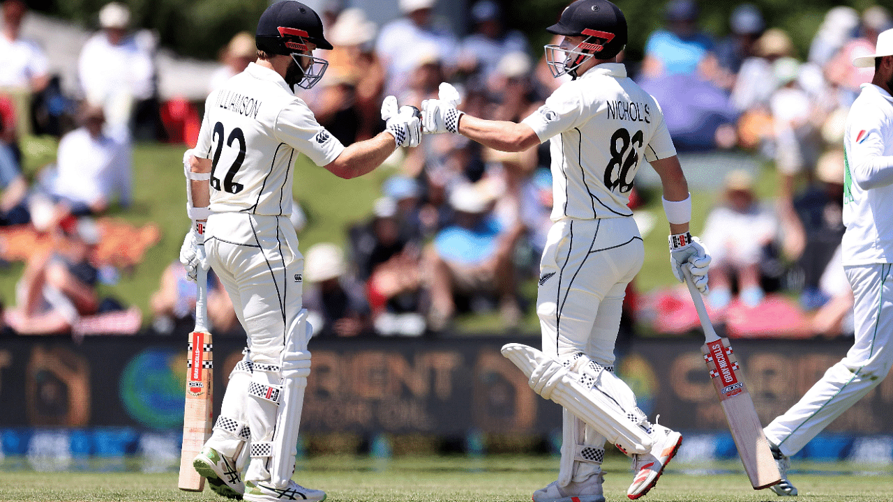 New Zealand's Henry Nicholls (R) celebrates 2000 career runs with captain Kane Williamson during day two of the second international cricket Test match between New Zealand and Pakistan. Credit: AFP Photo