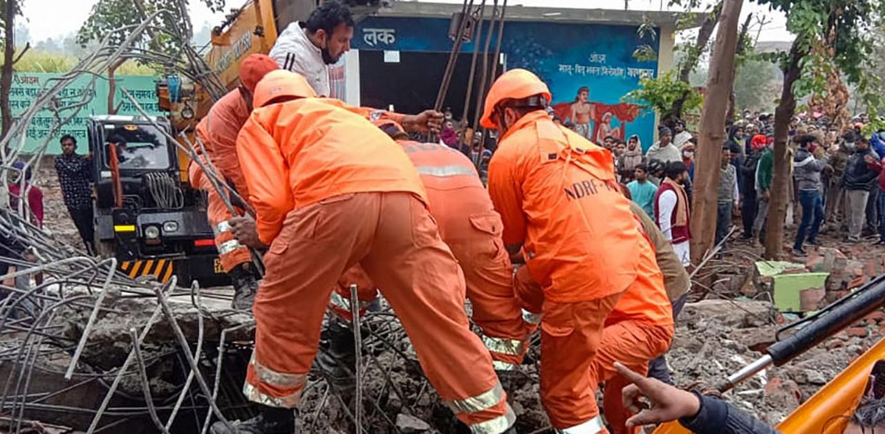 Rescue operation carried out by NDRF personnel after the complex roof of a crematorium collapsed due to heavy rain, at Muradnagar in Ghaziabad, Sunday, Jan. 03, 2021. Credit: PTI Photo