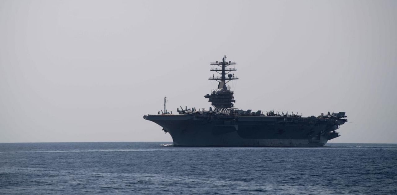 In this file handout photo taken on September 18, 2020 and released by the US Navy, the aircraft carrier USS Nimitz transits the Strait of Hormuz. Credit: AFP Photo