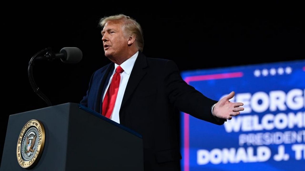 In this file photo taken on December 05, 2020 US president Donald Trump speaks at a rally to support Republican Senate candidates at Valdosta Regional Airport in Valdosta, Georgia. Credit: AFP.