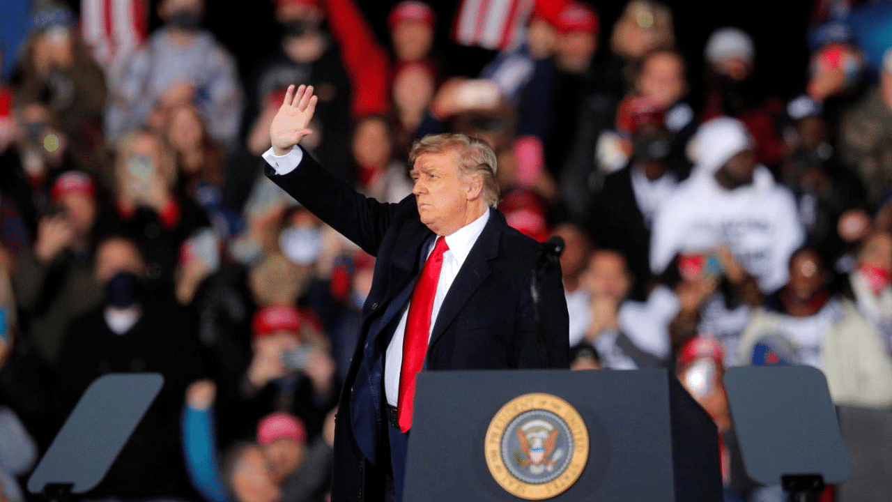 `US President Donald Trump waves at a campaign for Republican Senator Kelly Loeffler on the eve of the run-off election to decide both of Georgia's Senate seats, in Dalton, Georgia, US. Credit: Reuters