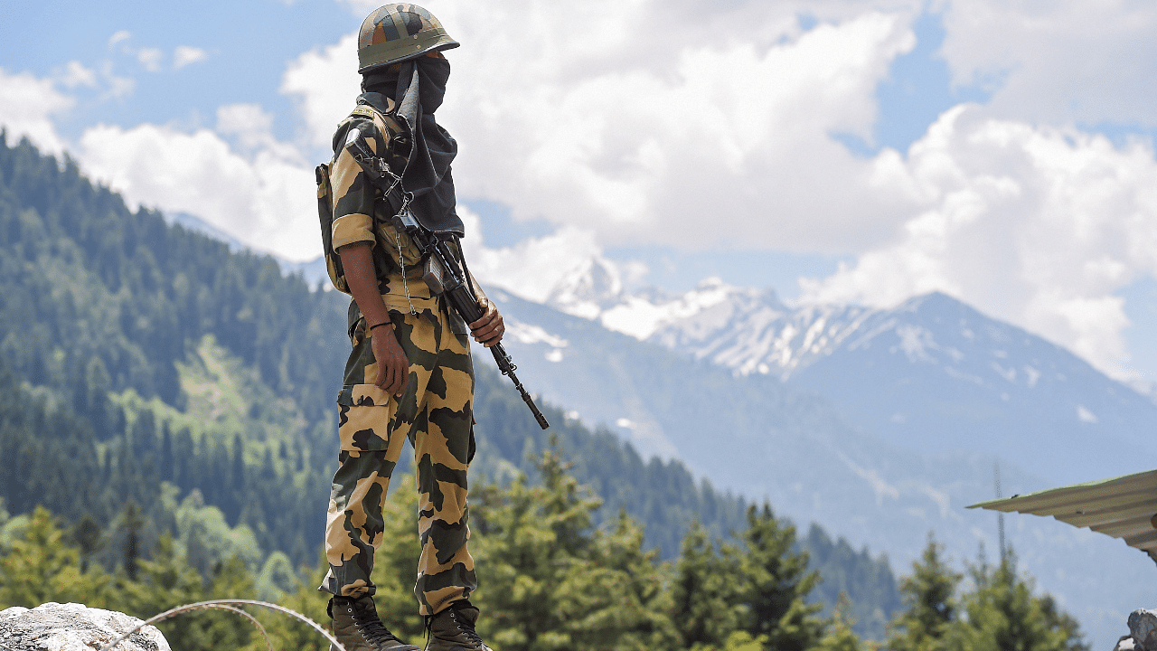 A Border Security Force (BSF) personnel stands guard along the Srinagar-Leh National highway, in Ganderbal district of Central Kashmir. Credit: PTI Photo