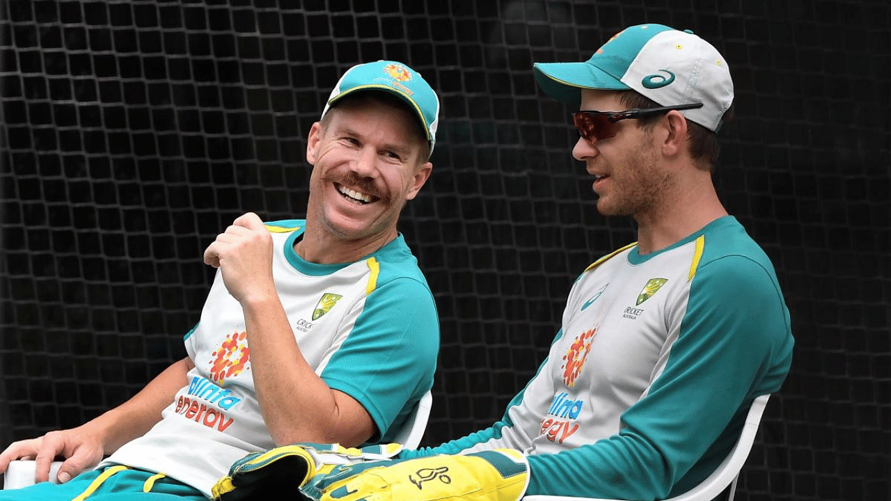 Australia's David Warner (L) chats with captain Tim Paine (R) in the nets during a training session at the MCG in Melbourne. Credit: AFP File Photo