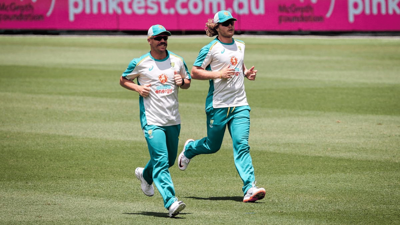 Australia's Will Pucovski (R) and David Warner jog during a training session at the Sydney Cricket Ground (SCG) ahead of the third cricket Test match against India. Credit: AFP File Photo