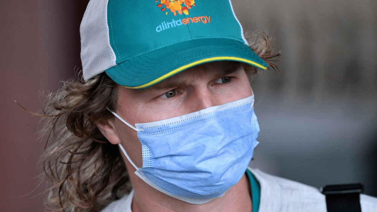 Australia's Will Pucovski arrives in face mask for a training session at the Sydney Cricket Ground (SCG) on January 6, 2021, ahead of the third cricket Test match against India. Credit: AFP Photo