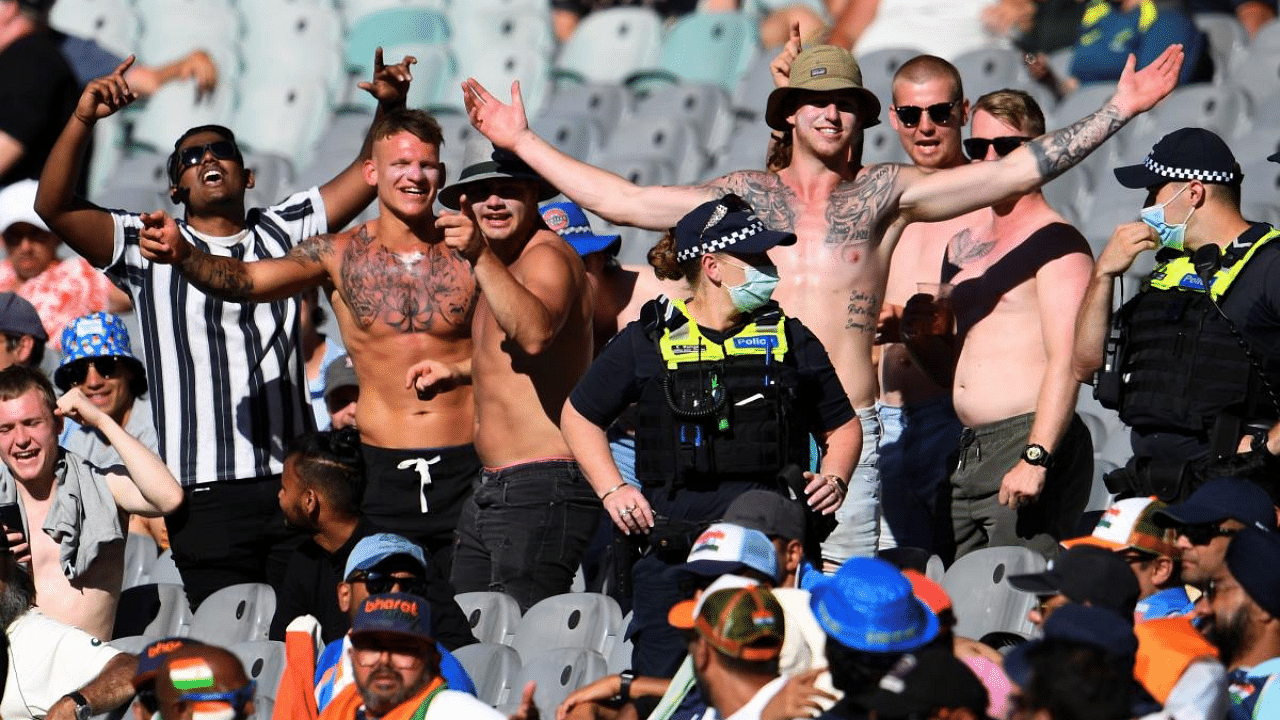 Police stand by as Australia fans heckle Indian supporters (in foreground) on the first day of the second cricket Test match between Australia and India at the MCG in Melbourne. Credit: AFP File Photo